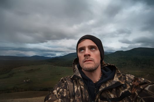 Caucasian man in the mountain making selfie on background nature landscape