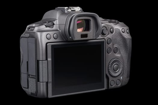 black 2020s professional 35mm full-frame mirrorless camera body with flip screen isolated on black background, rear view