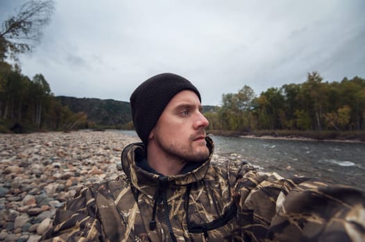 Caucasian man in the mountain making selfie on background nature landscape