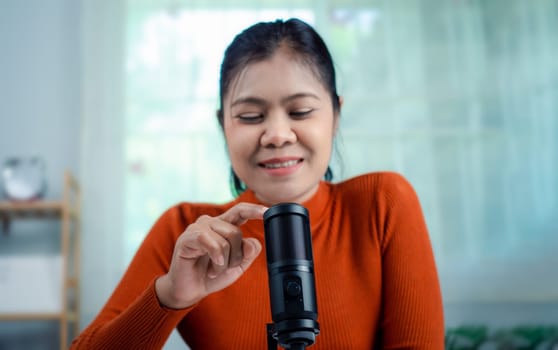 Woman talking into microphone on stand, lead on-line communication, discuss topic, virtual meeting event, Podcast, webinar, Content creator concept, live on social media, Recording podcast.