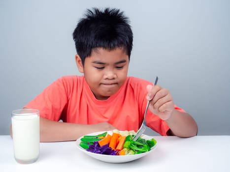 Children do not like to eat vegetables, Little cute boy refuses to eat healthy vegetables, Nutrition healthy eating habits for kids concept, Children do not like to eat vegetables.