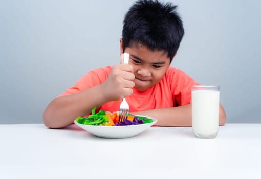 Children do not like to eat vegetables, Little cute boy refuses to eat healthy vegetables, Nutrition healthy eating habits for kids concept, Children do not like to eat vegetables.