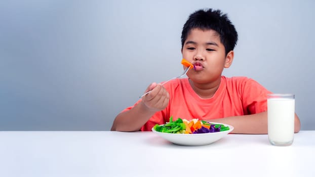 Children like to eat vegetables, Little cute boy eat healthy vegetables, Nutrition healthy eating habits for kids concept, Mixed color vegetables.