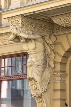 Lodz, Poland - May 4, 2023: Tenement house of Herman Konstadt, located on Piotrkowska street. Decorative facade with statue of atlas