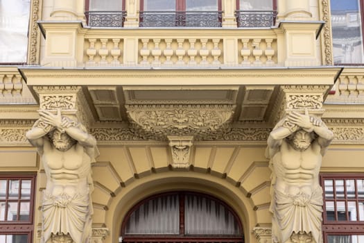 Lodz, Poland - May 4, 2023: Tenement house of Herman Konstadt, located on Piotrkowska street. Decorative facade with statue of atlas