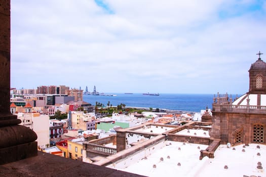 Gran Canaria, Spain, Canary Islands. View of the city of Las Palmas with part of the Santa Ana Cathedral, to the harbor and the sea from the belltower of the Cathedral.