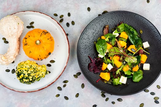 Plate of roasted pumpkin with salad. Roasted butternut squash salad. Healthy diet concept.