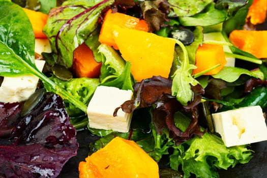 Plate of roasted pumpkin with salad. Roasted butternut squash salad. Healthy diet concept.