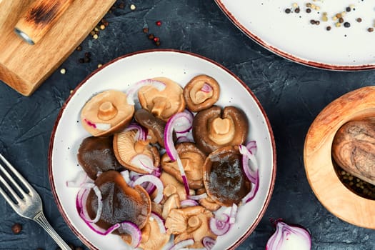Salted mushrooms in a plate. Homemade pickled mushrooms