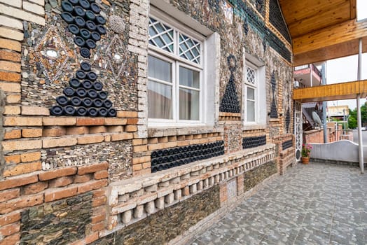 The Bottle House in Ganja features an intricate design made from glass bottles and local materials, attracting visitors with its creative architecture and vibrant exterior