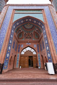 The stunning entrance of the Imamzadeh Mausoleum in Ganja, Azerbaijan, showcasing vibrant tile work, brickwork, and unique architectural details that reflect the region's rich history