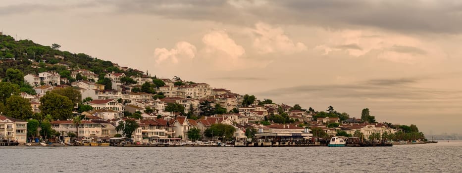 Kinaliada Island showcases hillside homes against a stunning sunset, reflecting the charm of Turkish island life