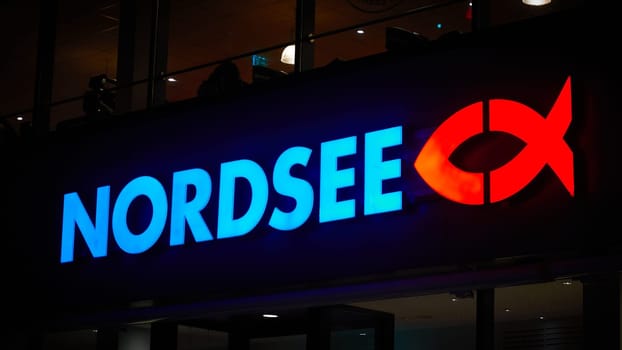 Illuminated sign for the German fast-food chain Nordsee in the evening in Berlin
