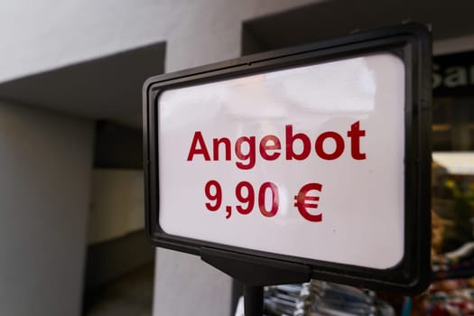 Sign advertising a special offer of 9.90 euros outside a store in Germany. Translation: special offer of 9.90 euros