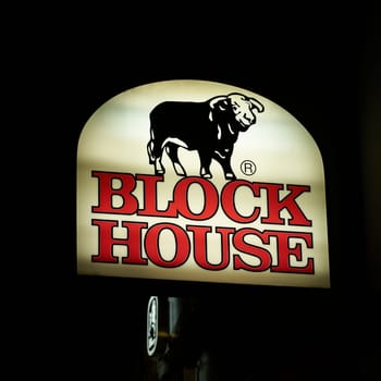 Illuminated sign of the German steakhouse chain Block House of Eugen Block Holding GmbH at night in Berlin
