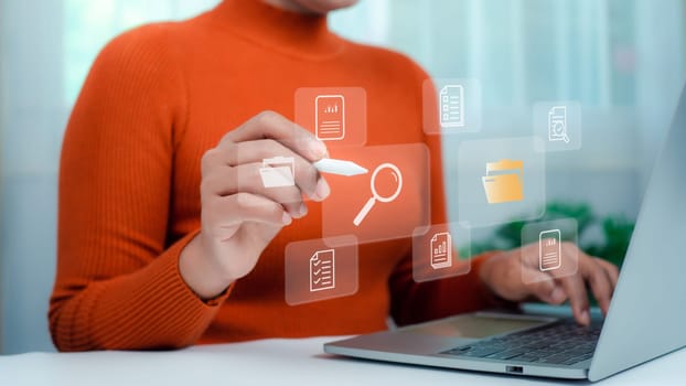 Businesswoman using laptop, Document management system concept, Folders and document icon software, Online document database file management Powerful company information Search and archive.