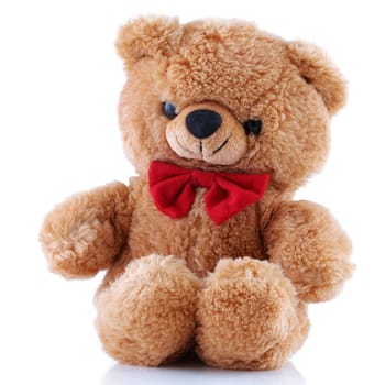A small Teddy Bear with red bow tie smiling