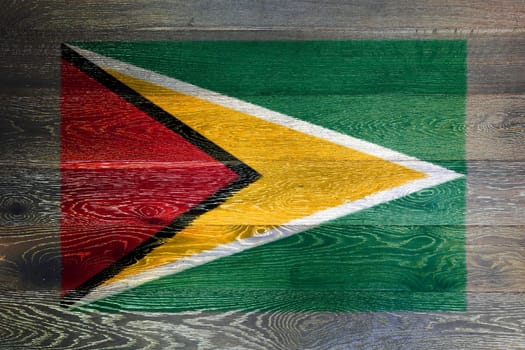 Guyana flag on rustic old wood surface background red yellow green star black
