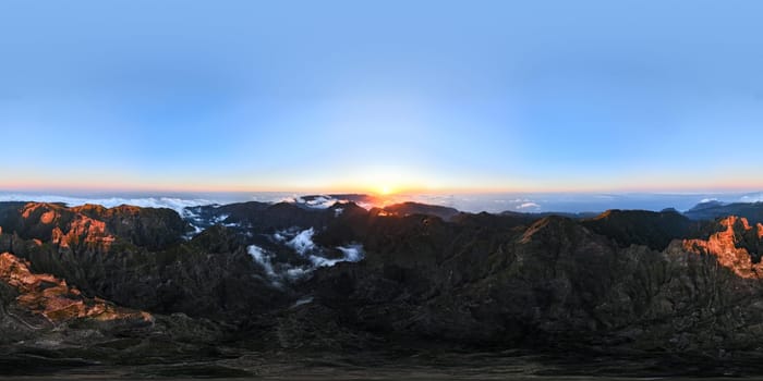 360 panorama of aerial drone view of mountains over clouds near Pico Ruivo on sunset. Madeira island, Portugal