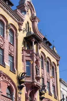 Lodz, Poland - May 4, 2023: Piotrkowska street, famous cult place, the main thoroughfare in city, decorative facade of tenement house of rich 19th-century manufacturers. House under Gutenberg