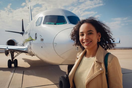 Happy Latina woman near plane before landing.
