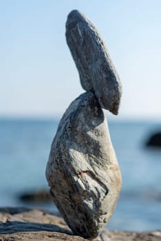 balanced stones on the rocks of the sea