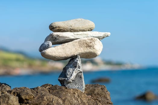 balanced stones on the rocks of the sea