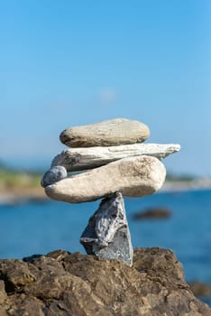 balanced stones on the rocks of the sea