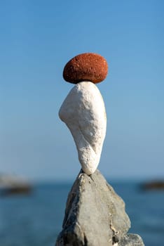 balanced stones on the rocks of the sea