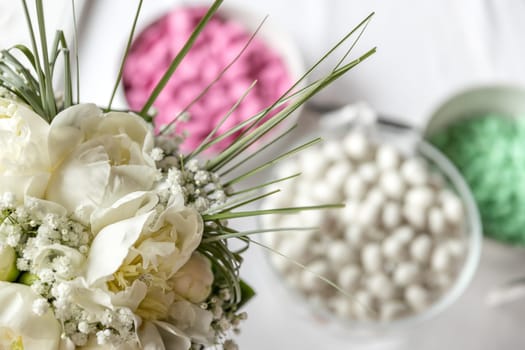 Bridal bouquet and italian confetti on blurry background. Bridal bouquet closeup.