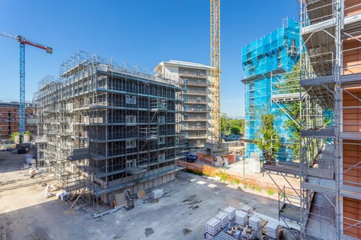 New construction site with cranes. Construction machinery. Construction site of modern apartment buildings.
