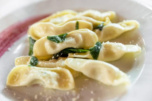Scarpinocc are typical ravioli from Bergamo, with a characteristic flattened shape. They differ from Casoncelli, typical of the town of Parre, in shape and filling: the latter is lean, but rich and tasty thanks to Grana Padano DOP, breadcrumbs, eggs, milk and spices.