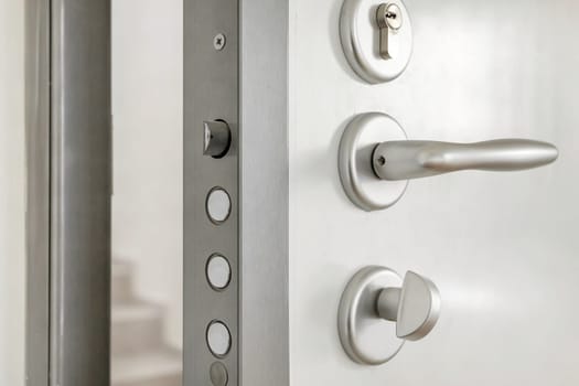 Close-up look at high security lock of an white armored home door