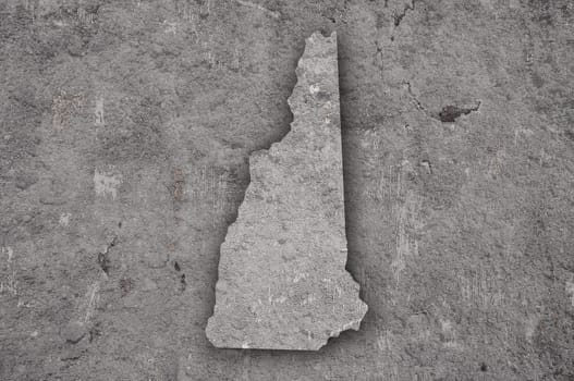 Map of New Hampshire on weathered concrete