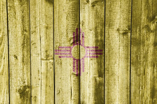 Flag of New Mexico on old wooden wall