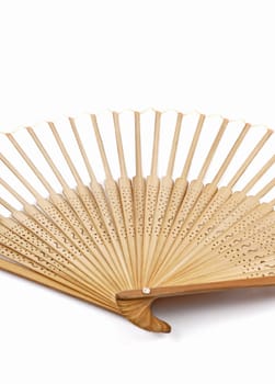 Detail of a hand held fan out of bamboo on a white background