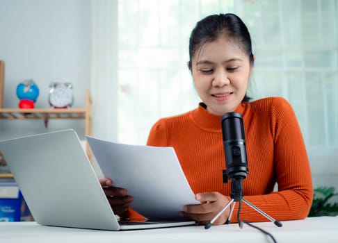 Podcast, Webinar, Content creator concept, woman talking into microphone on stand, lead on-line communication, discuss topic, looks at notebook screen, Engaged in streaming, Virtual meeting event.