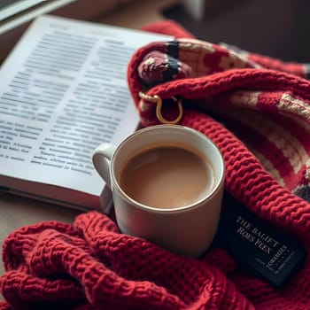 A warm cup of coffee sits beside an open book, wrapped in a cozy red blanket, as daylight streams in through the window, creating a serene autumn atmosphere perfect for relaxation.