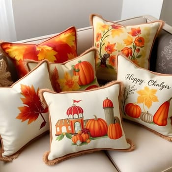 A collection of vibrant decorative pillows featuring autumn motifs such as pumpkins and falling leaves is arranged on a cozy couch, creating a warm seasonal ambiance.