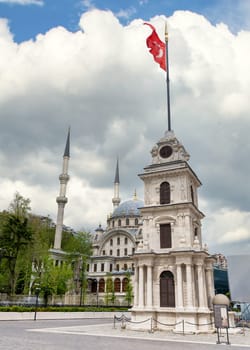 Nusretiye Clock Tower, aka Tophane Clock Tower, with Nusretiye imperial Ottoman ornate Mosque in the background, located inside Galata Port, Tophane neighborhood, Beyoglu district, Istanbul, Turkey