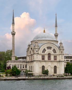 View from Bosphorus strait overlooking Baroque style Dolmabahce Mosque, suited at the waterside of Kabatas, in Beyoglu district, Istanbul, Turkey
