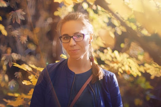 Woman autumn portrait in warm sunny october day with natural light.