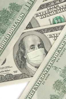 Portrait of Franklin on 100 dollar banknote with medical mask. The concept of coronavrius epidemic and the financial crisis caused by this collapse