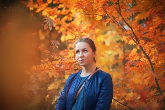 Woman autumn portrait in warm sunny october day with natural light.
