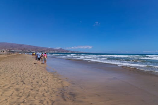 Gran Canaria, Spain - March 20, 2024: People visit Playa Ingles beach in Maspalomas, Gran Canaria. Spain