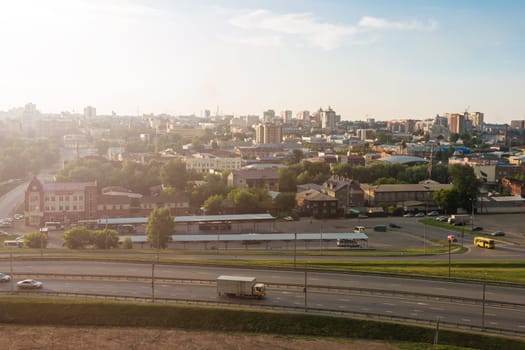 Panoramic picture of road and cars driving, summer sunny day in Barnaul, Siberia, Russia