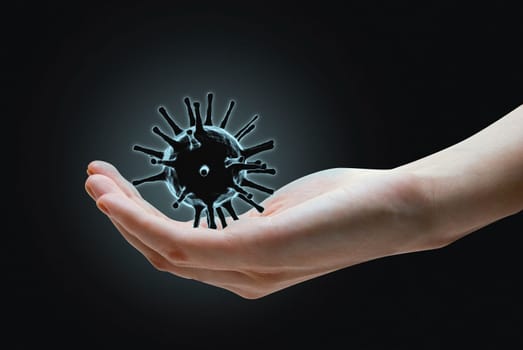 Hand with corona virus COVID-2019 on black background.
