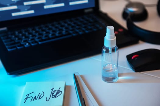 Concept of loss and searching job by reason of coronavirus covid-19. Sanitizer anti virus spray on the working table with laptop.