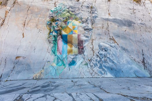 Colonnata di Carrara, Italy - 08 August 2024: the famous David murales by Kobra, inspired by Michelangelo. Street art on white marble, made in 2017.