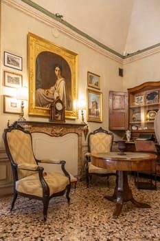 Masino, Italy - 12 December 2023: old apartment interior, early 20th century furniture, living room, nobody